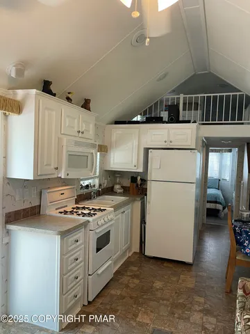 a kitchen with a stove and a refrigerator