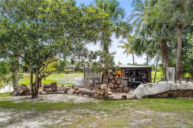 a view of empty room with wooden floor and window