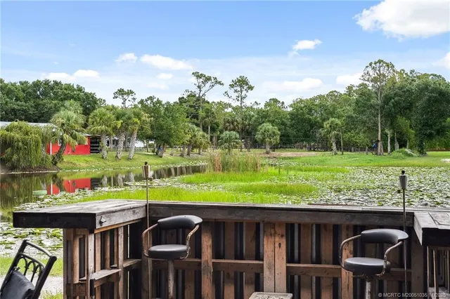 a kitchen with stainless steel appliances granite countertop a refrigerator a stove and a sink with wooden cabinets