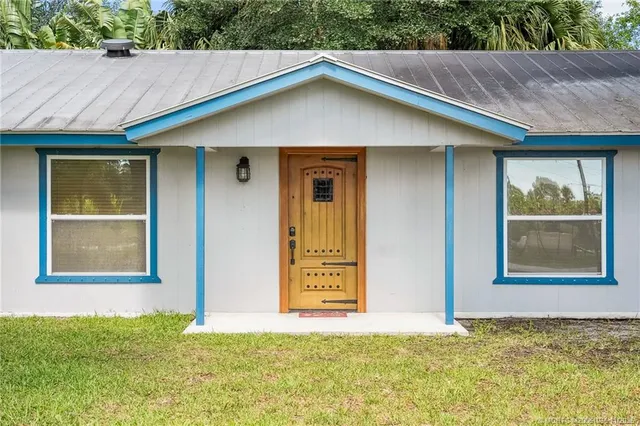 a spacious bedroom with a bed a dresser and a window