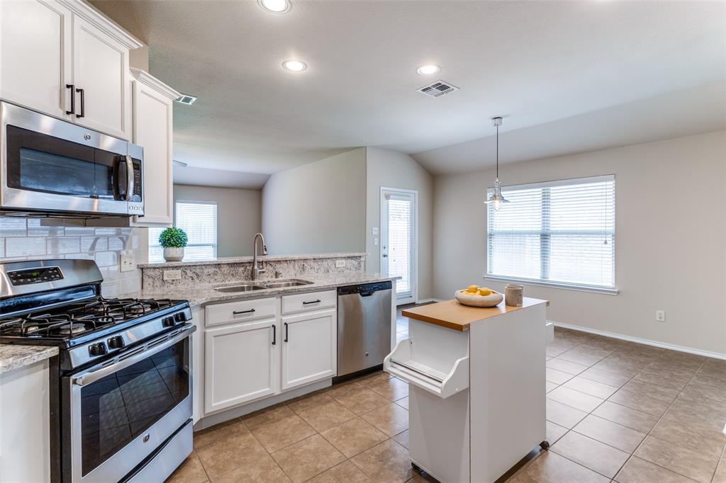 3806 Spring Run Lane Melissa, TX 75454 - Photo 1 of 23 a kitchen with stainless steel appliances granite countertop a stove a sink and a microwave