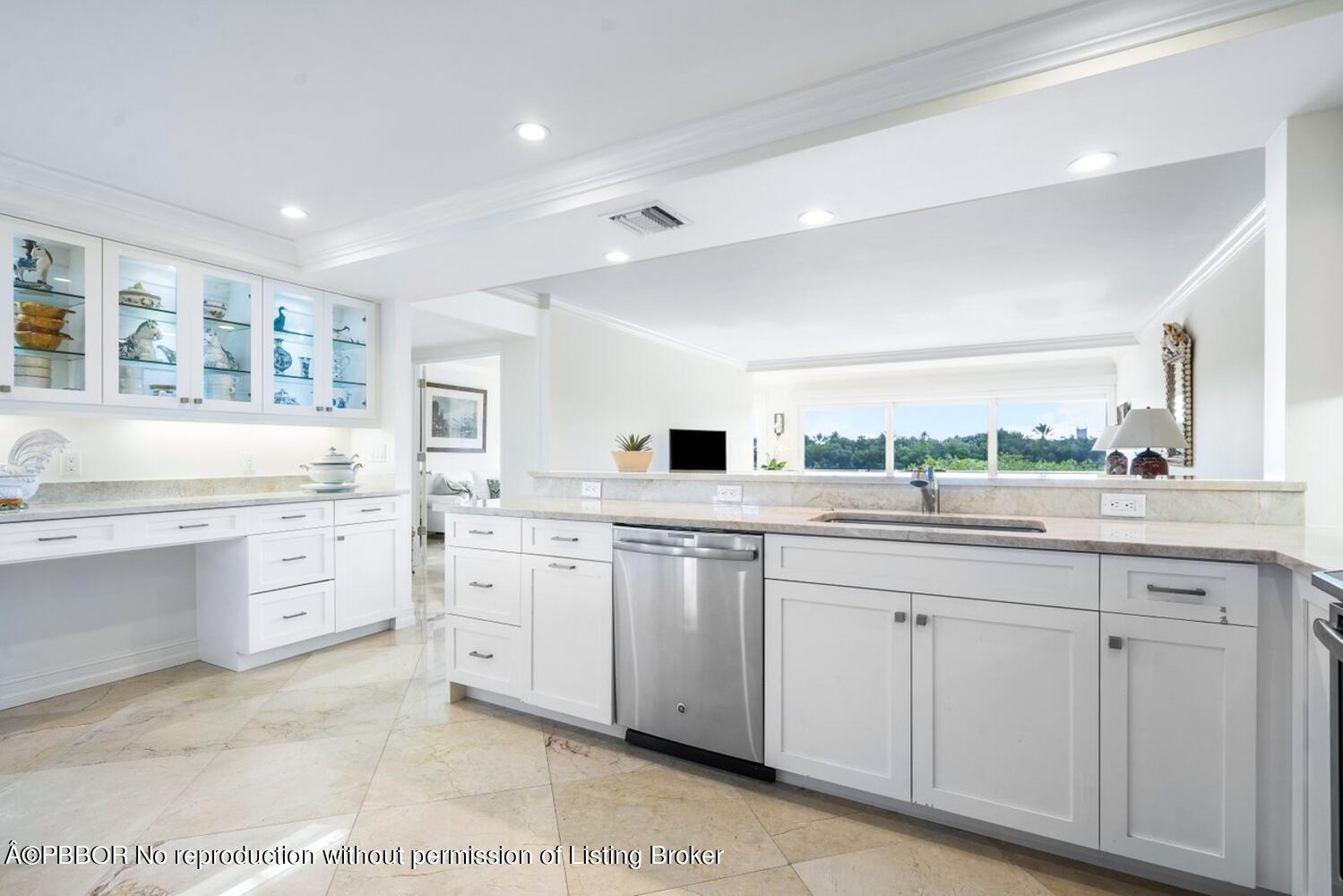 2195 Ibis Isle Road, Unit 7 Palm Beach, FL 33480 - Photo 11 of 34 a kitchen with white cabinets and sink