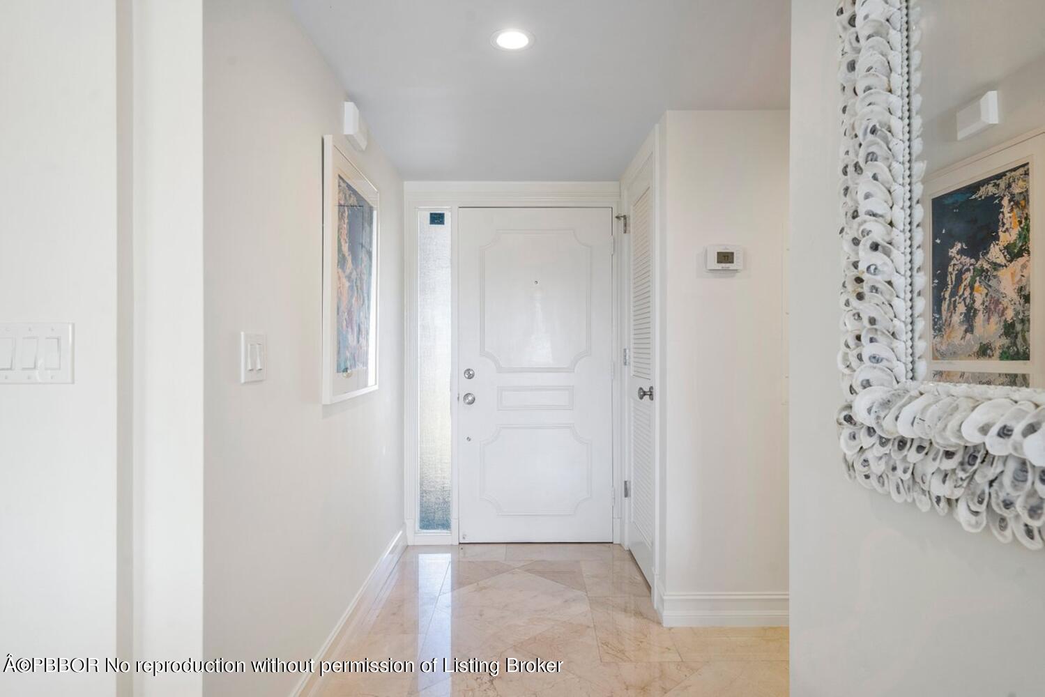 2195 Ibis Isle Road, Unit 7 Palm Beach, FL 33480 - Photo 14 of 34 a view of a hallway with paintings on the wall