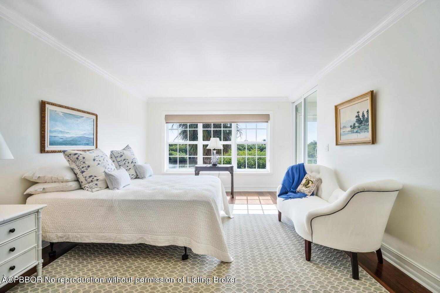 2195 Ibis Isle Road, Unit 7 Palm Beach, FL 33480 - Photo 15 of 34 a bedroom with a bed and glass window