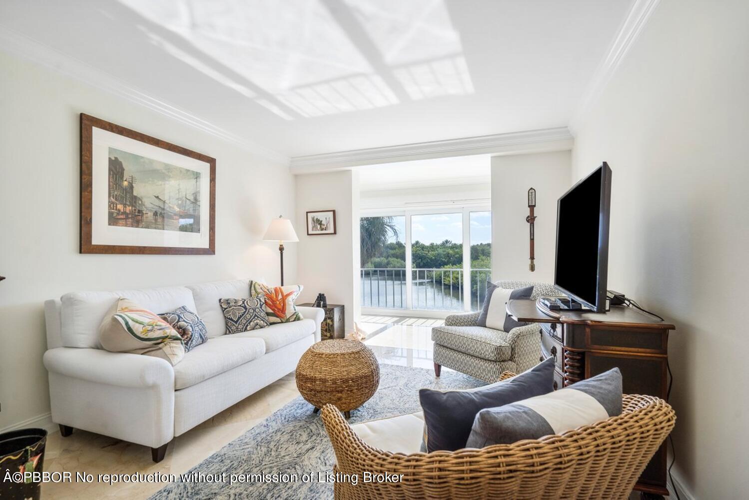 2195 Ibis Isle Road, Unit 7 Palm Beach, FL 33480 - Photo 22 of 34 a living room with furniture a flat screen tv and a large window