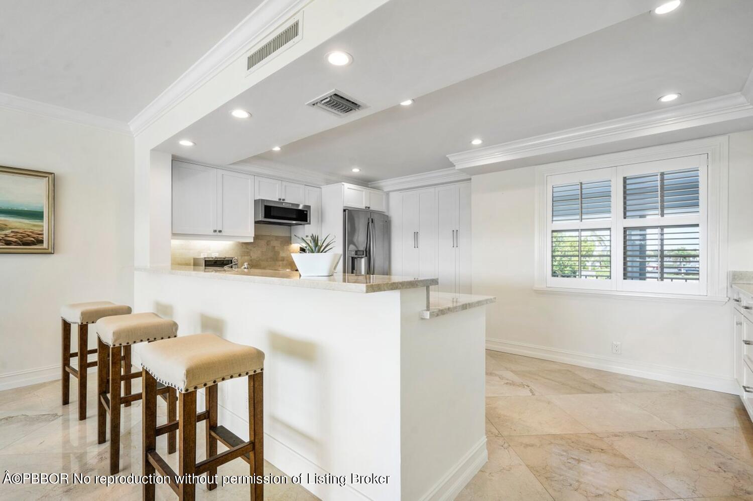 2195 Ibis Isle Road, Unit 7 Palm Beach, FL 33480 - Photo 9 of 34 a living room with stainless steel appliances kitchen island granite countertop furniture and a window