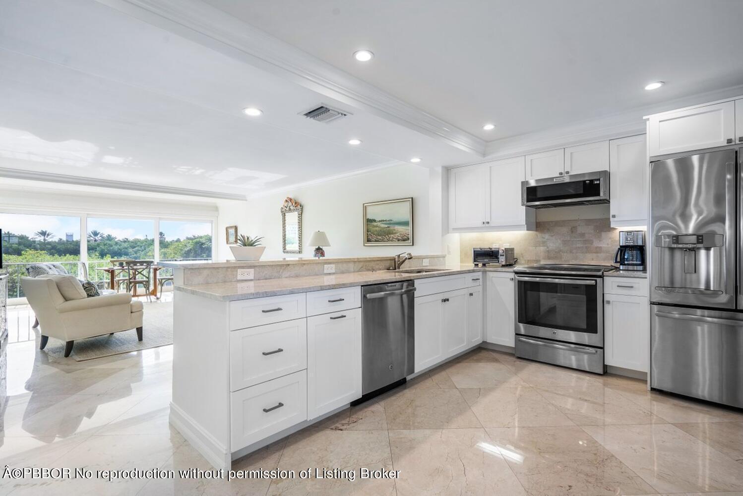 2195 Ibis Isle Road, Unit 7 Palm Beach, FL 33480 - Photo 10 of 34 a kitchen with granite countertop a refrigerator and a stove top oven