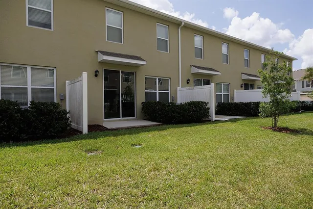 a view of a big yard with plants and a large tree