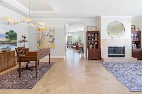 a living room with fireplace furniture and a flat screen tv