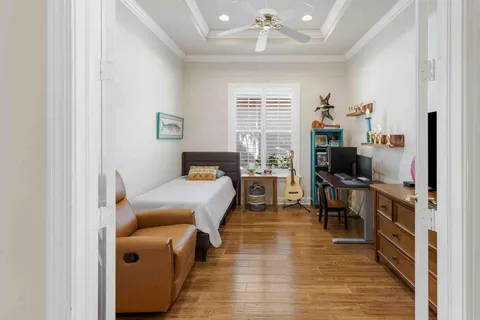 a bedroom with a bed window and a desk