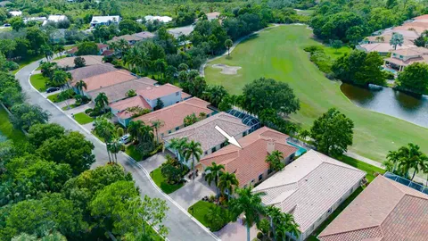 a view of a swimming pool with a patio and fire pit