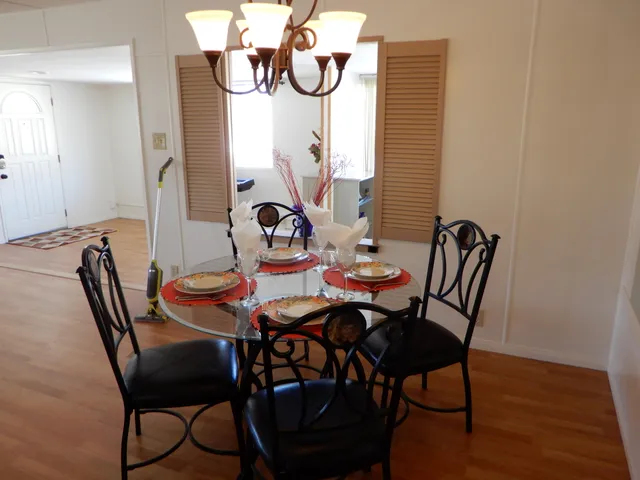 a dining room with furniture and wooden floor