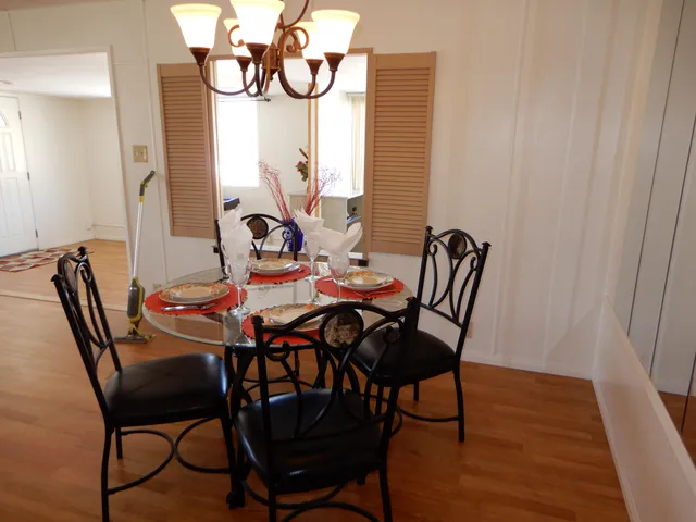 a view of a dining room with furniture and wooden floor