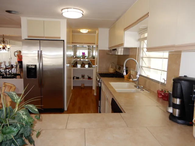 a kitchen with refrigerator and cabinets