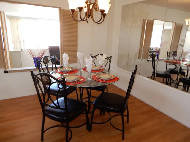 a view of a dining room with furniture and window