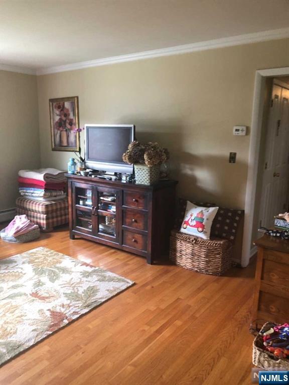 79 Rock Road, Unit 1 Hawthorne, NJ 07506 - Photo 4 of 12 a room with furniture and a flat screen tv