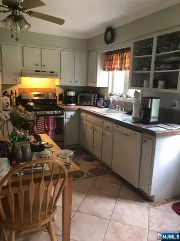 a kitchen with sink cabinets and window
