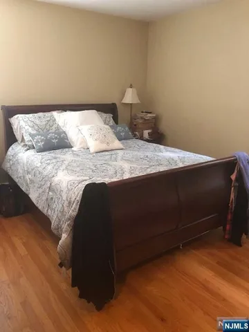 a bedroom with a bed and a night stand