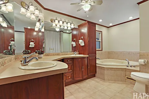 a bathroom with a bathtub a double vanity sink and a mirror