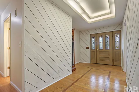 a view of a hallway with wooden cabinets