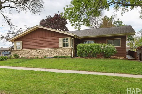 a front view of house with yard and green space