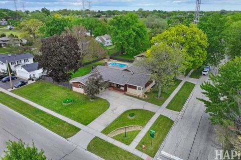 an aerial view of a house with outdoor space and swimming pool
