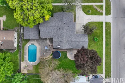 an aerial view of house with yard swimming pool and outdoor seating