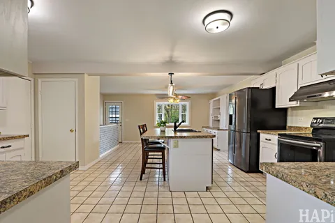 a kitchen with a stove a refrigerator and a sink
