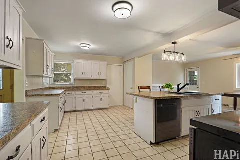 a kitchen with stainless steel appliances granite countertop a sink and cabinets