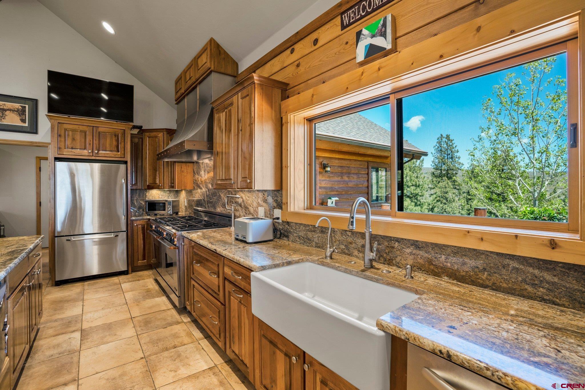 50 West Durango Ridge Road Durango, CO 81301 - Photo 13 of 45 a kitchen with stainless steel appliances granite countertop a sink and a refrigerator