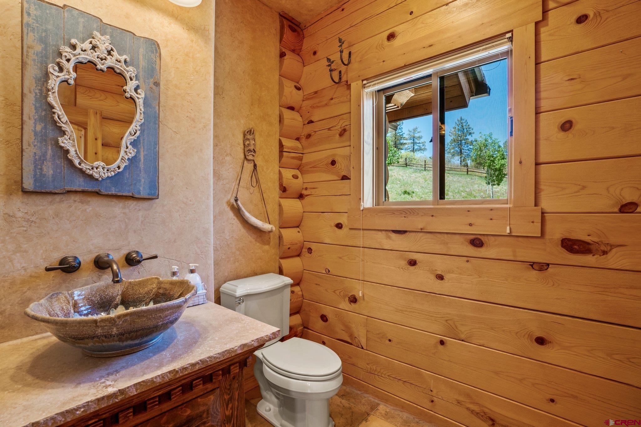 50 West Durango Ridge Road Durango, CO 81301 - Photo 14 of 45 a bathroom with a toilet a sink and a window