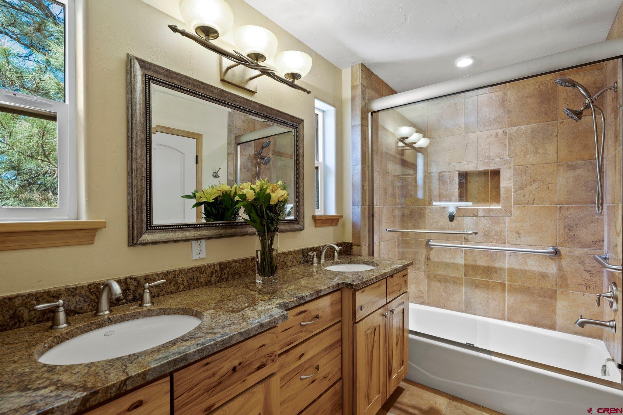 50 West Durango Ridge Road Durango, CO 81301 - Photo 28 of 45 a bathroom with a granite countertop sink mirror and a bathtub