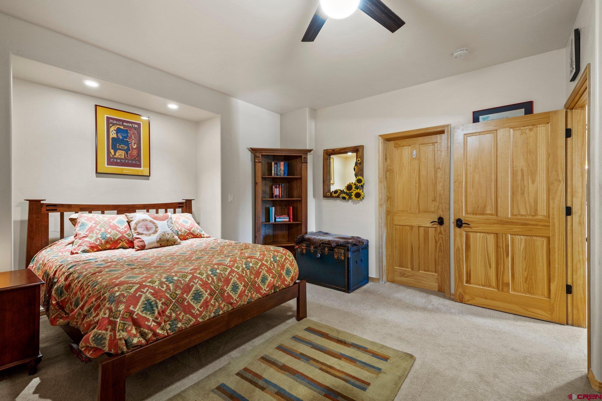 50 West Durango Ridge Road Durango, CO 81301 - Photo 38 of 45 a bedroom with a bed and a chandelier