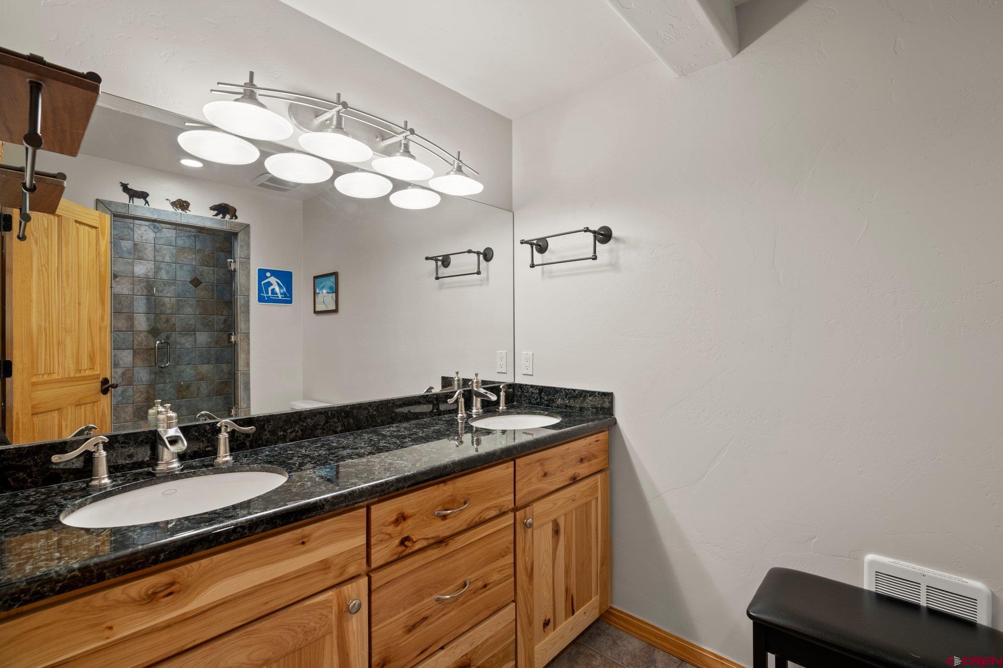 50 West Durango Ridge Road Durango, CO 81301 - Photo 42 of 45 a bathroom with a granite countertop double vanity sink and mirror