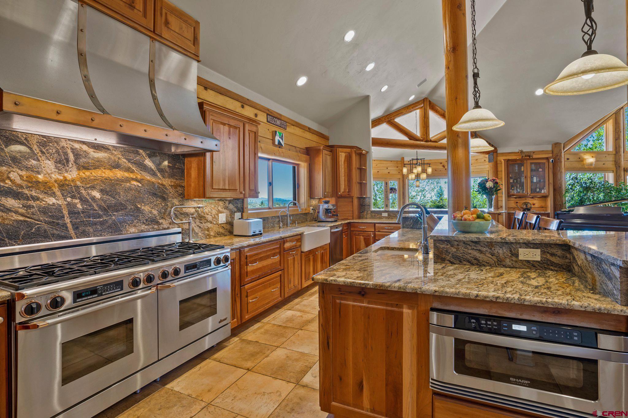 50 West Durango Ridge Road Durango, CO 81301 - Photo 5 of 45 a kitchen with stainless steel appliances granite countertop a stove a sink and a microwave