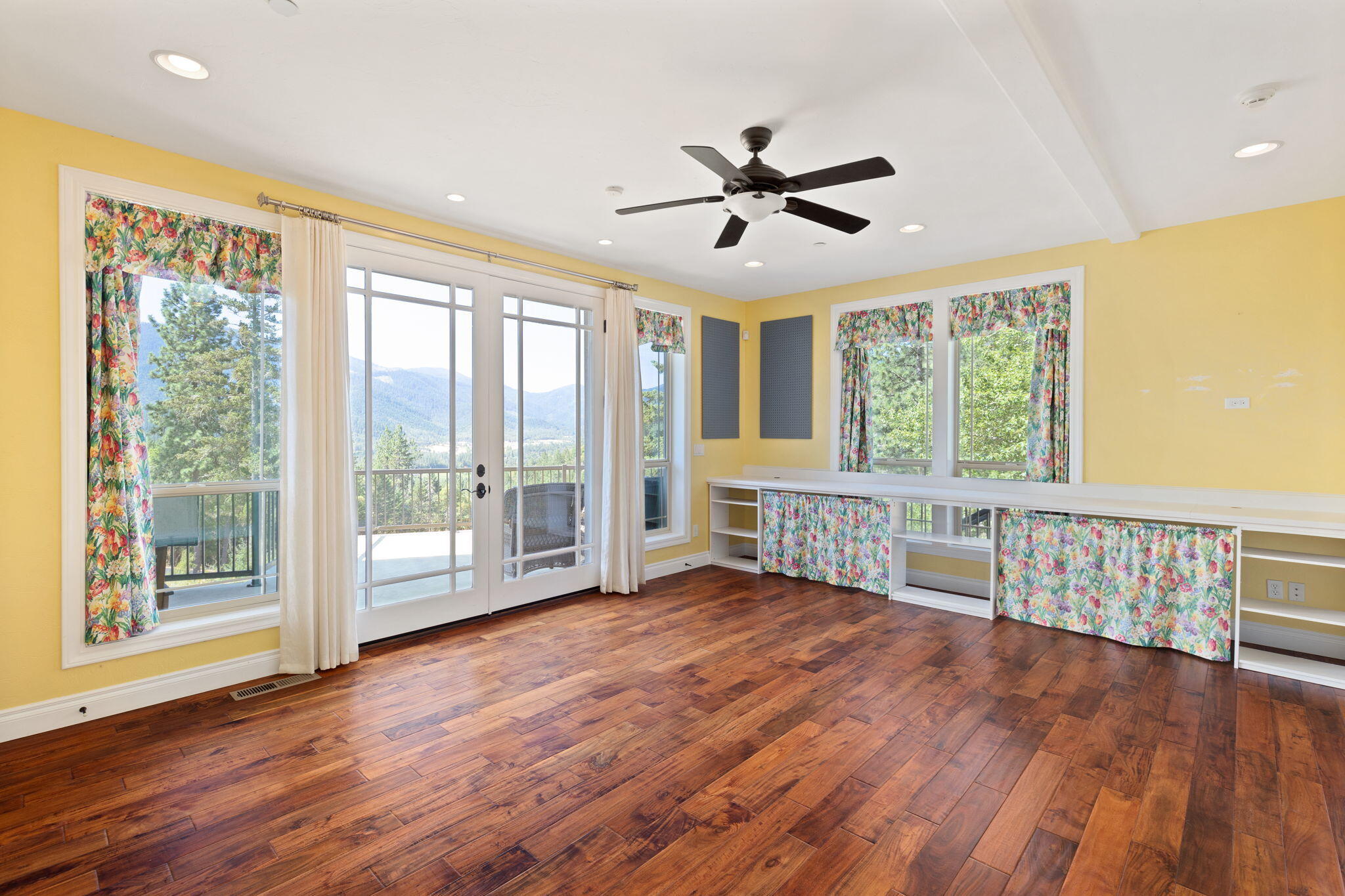 7304 North Applegate Road Grants Pass, OR 97527 - Photo 25 of 87 a view of an empty room with wooden floor and a window