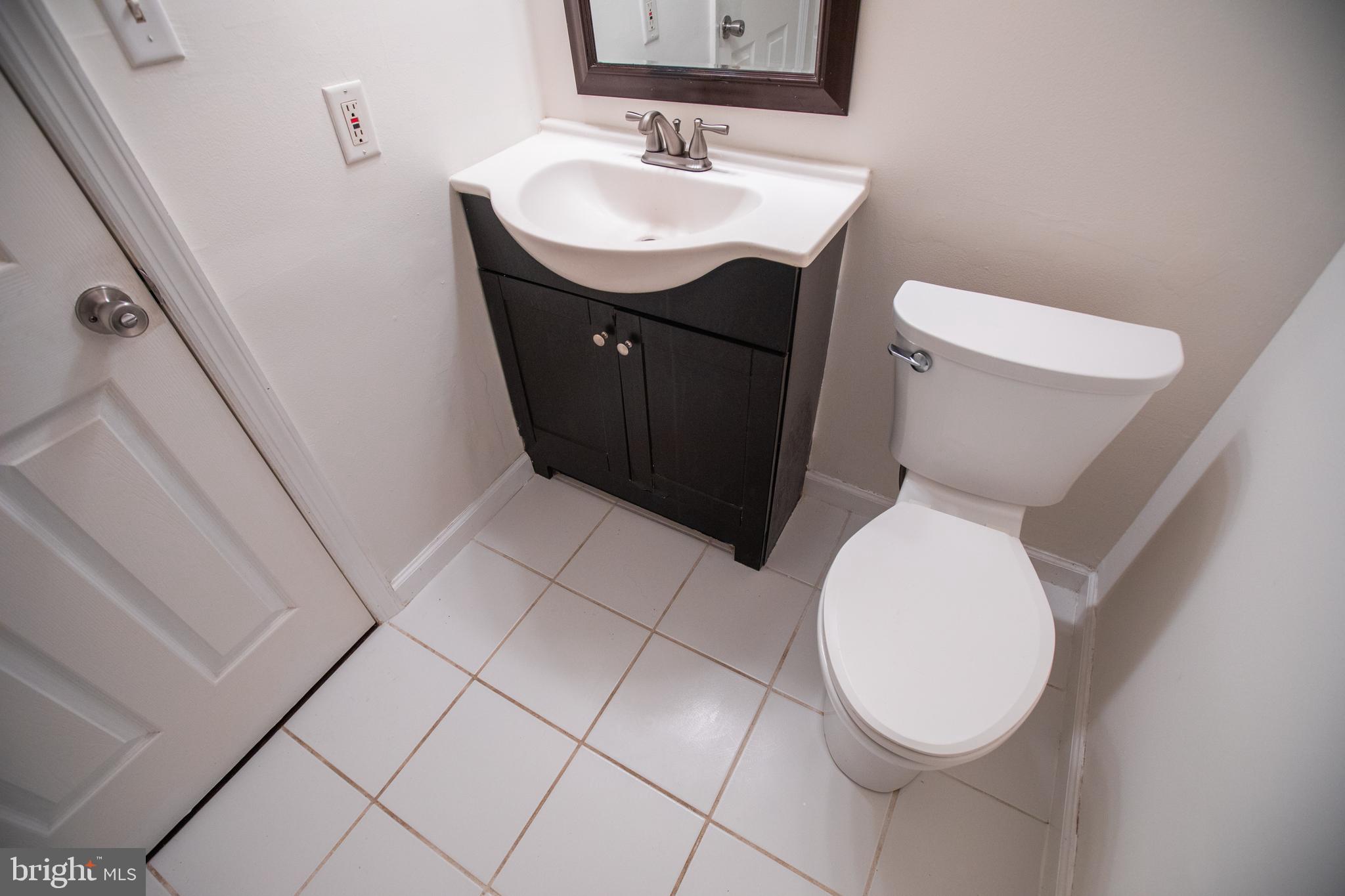 43 Fairmount Avenue Sicklerville, NJ 08081 - Photo 14 of 24 a bathroom with a sink a toilet and a mirror