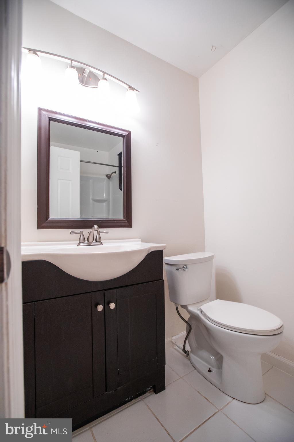 43 Fairmount Avenue Sicklerville, NJ 08081 - Photo 15 of 24 a bathroom with a toilet sink and mirror