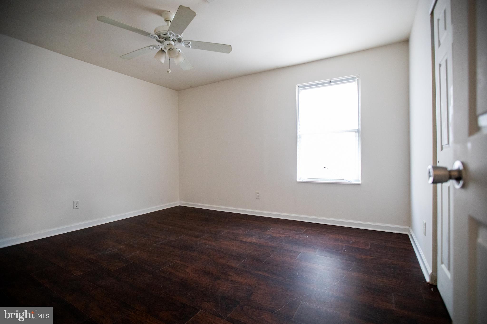 43 Fairmount Avenue Sicklerville, NJ 08081 - Photo 20 of 24 an empty room with wooden floor fan and windows