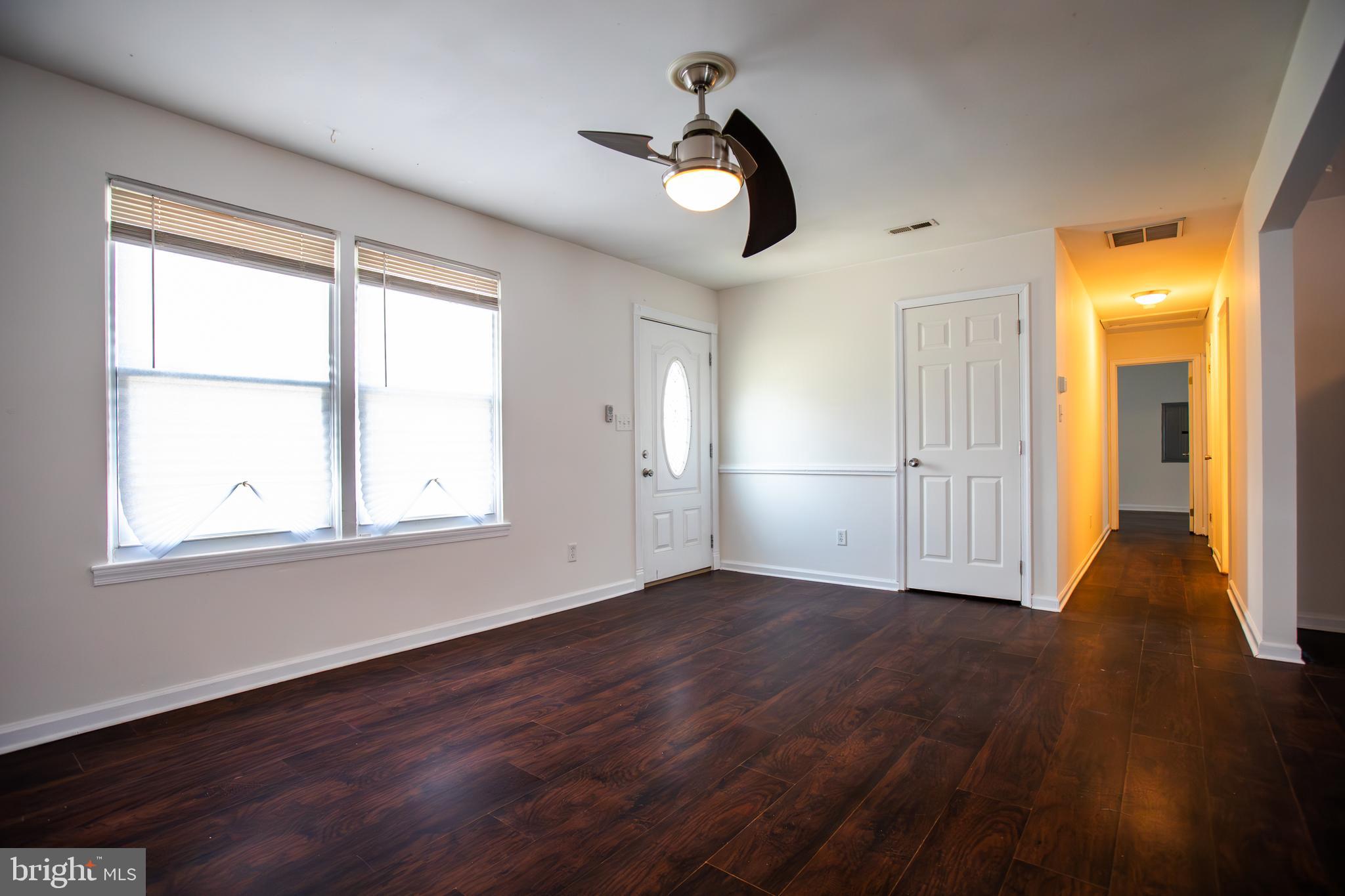 43 Fairmount Avenue Sicklerville, NJ 08081 - Photo 3 of 24 an empty room with wooden floor cabinet and windows