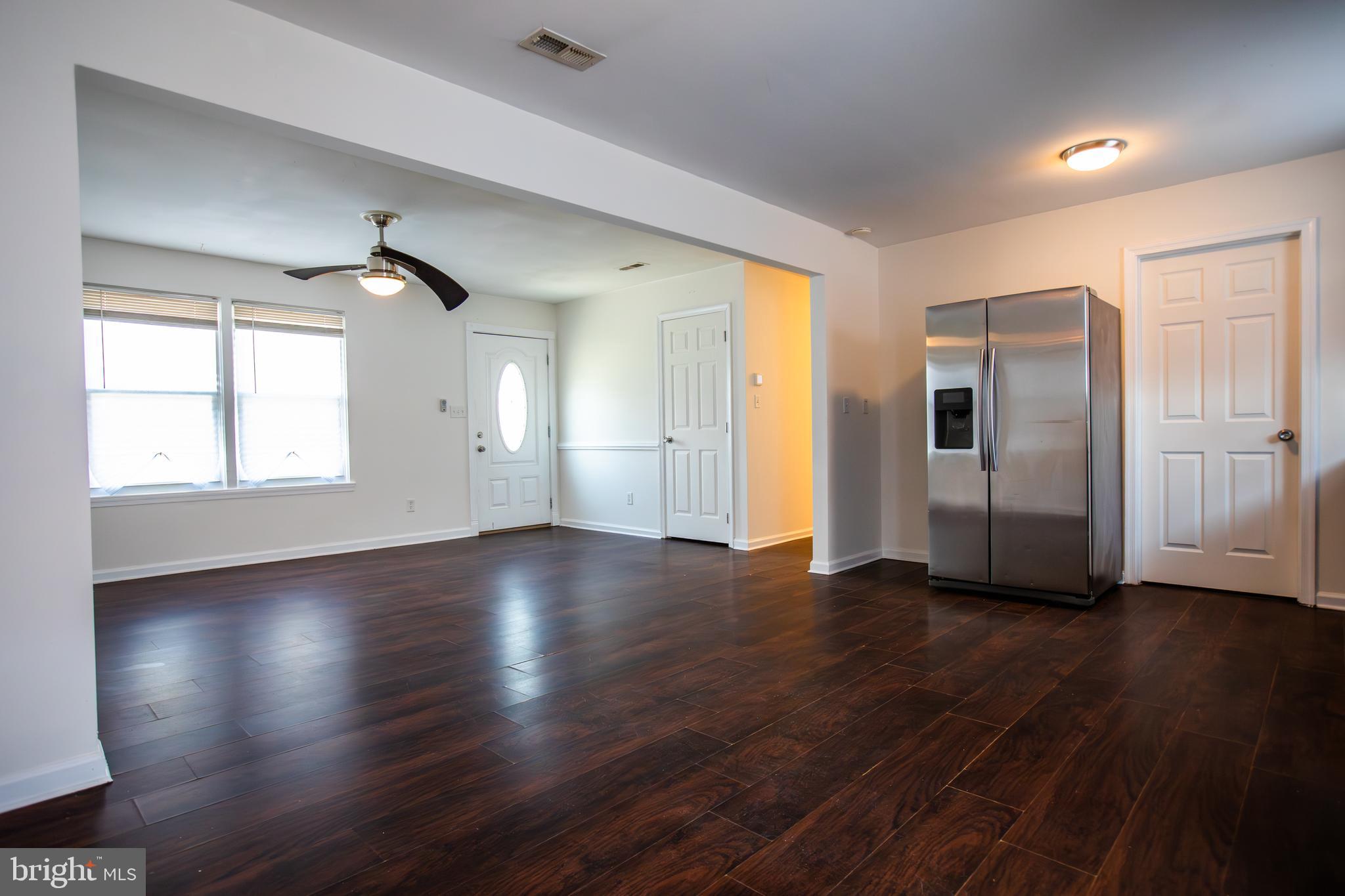43 Fairmount Avenue Sicklerville, NJ 08081 - Photo 4 of 24 a view of an empty room with wooden floor and a window