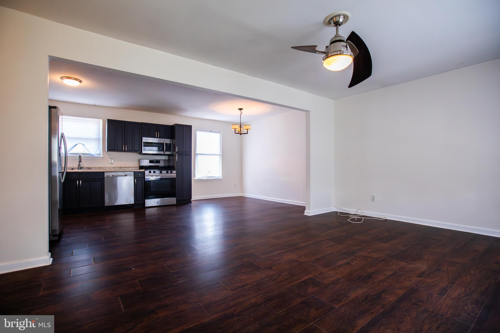 43 Fairmount Avenue Sicklerville, NJ 08081 - Photo 5 of 24 an empty room with wooden floor kitchen view and a window