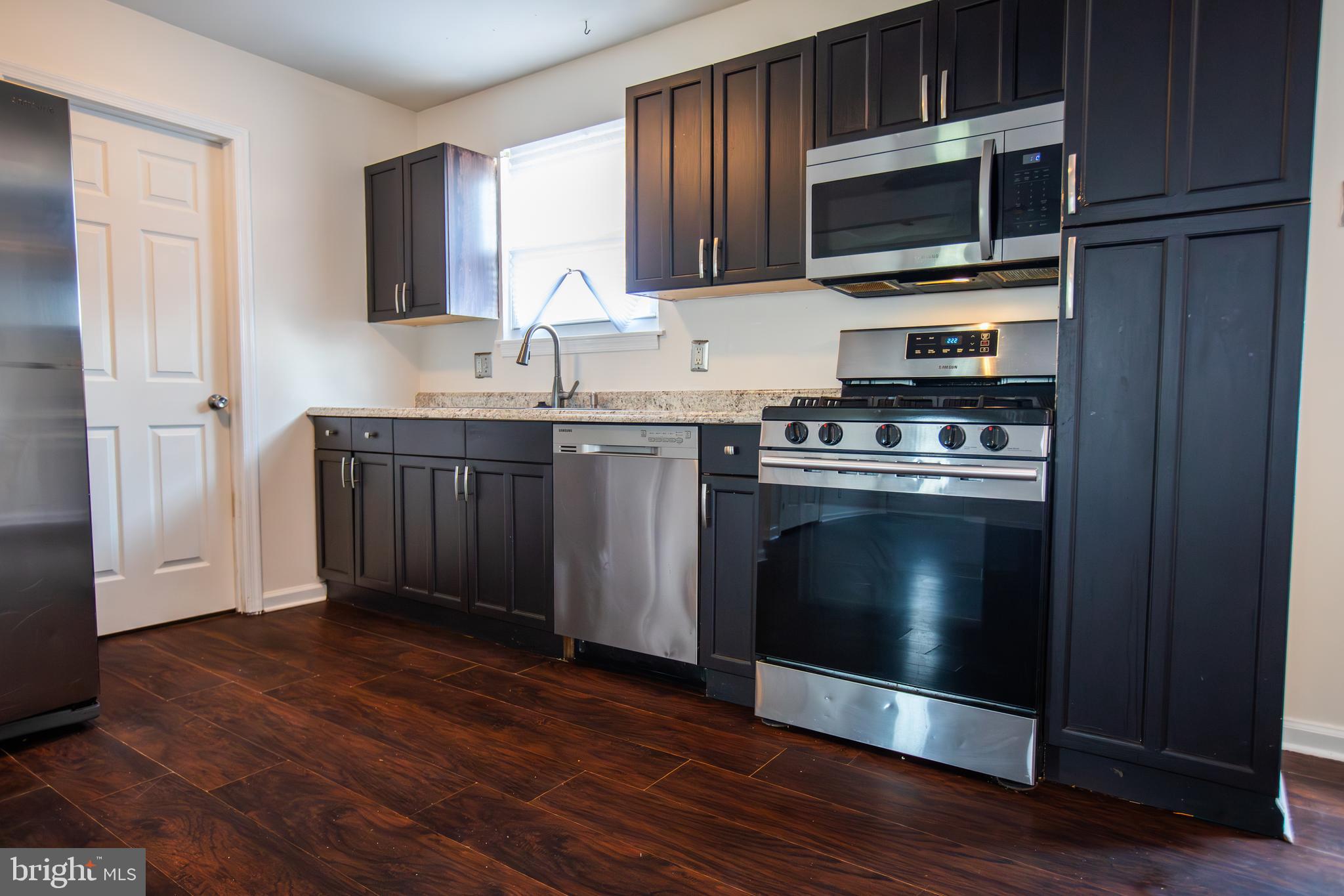 43 Fairmount Avenue Sicklerville, NJ 08081 - Photo 6 of 24 a kitchen with stainless steel appliances granite countertop wooden cabinets a stove top oven a sink and dishwasher