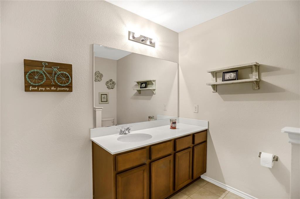 2302 San Marcos Drive Forney, TX 75126 - Photo 12 of 27 a bathroom with a sink and a mirror