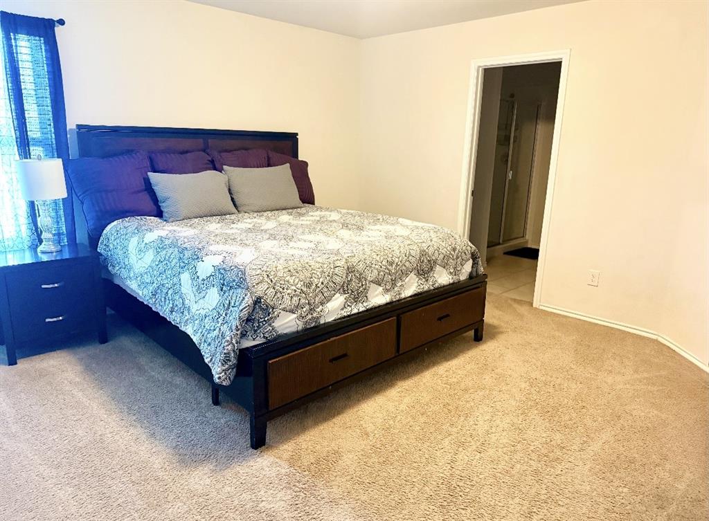 2302 San Marcos Drive Forney, TX 75126 - Photo 10 of 27 a bed sitting in a bedroom next to a bathroom