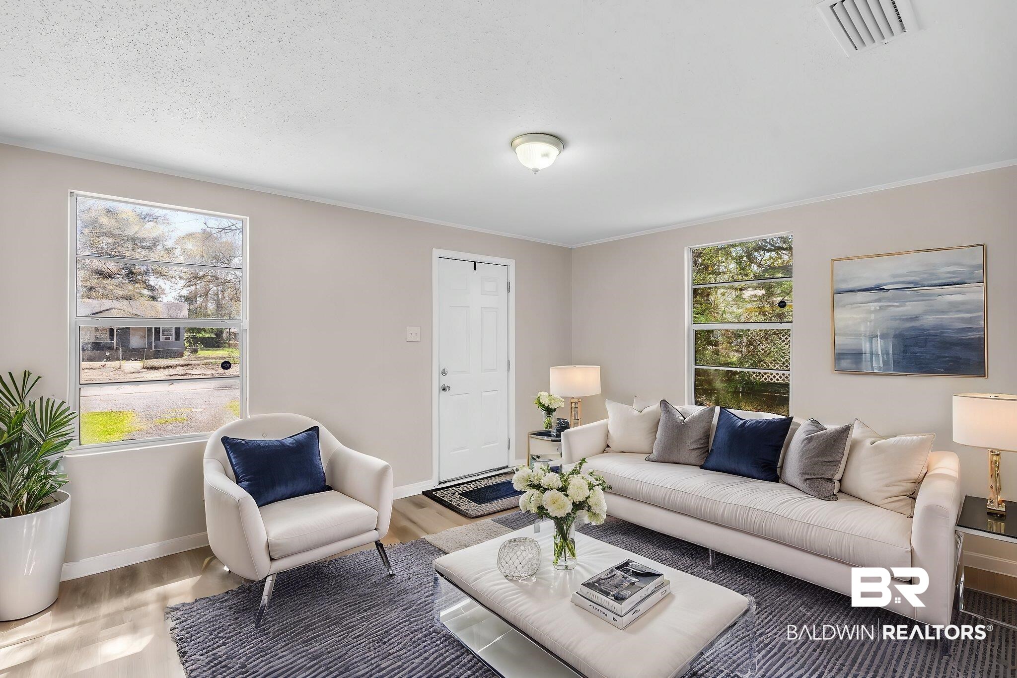 66 11th Avenue Chickasaw, AL 36611 - Photo 4 of 15 Living room with light wood finished floors, visible vents, baseboards, and a wealth of natural light
