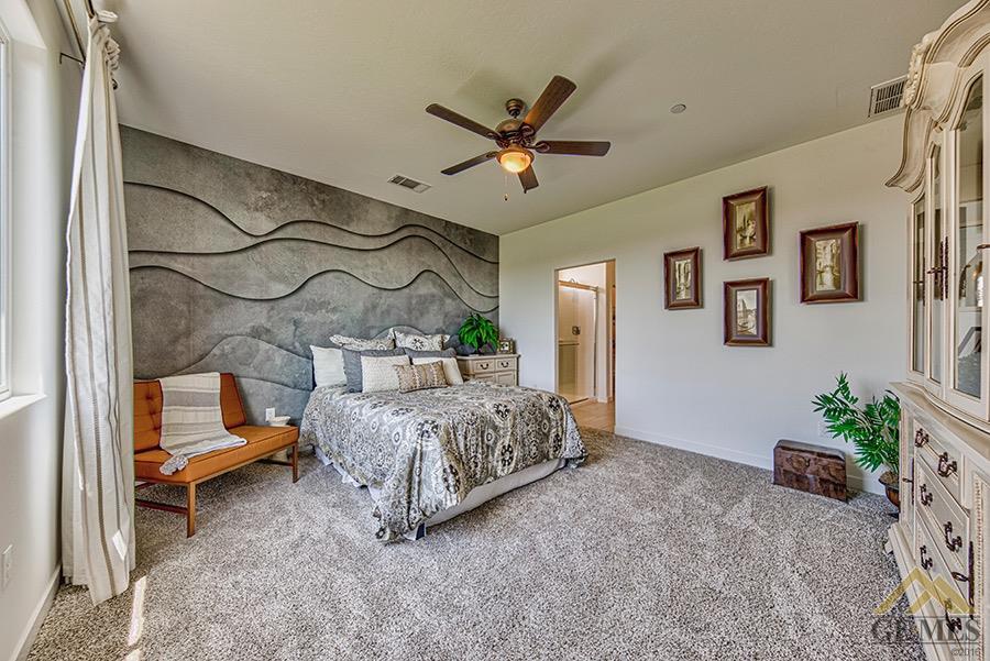 Undisclosed Address Bakersfield, CA 93311 - Photo 5 of 12 a bedroom with a bed and a chandelier