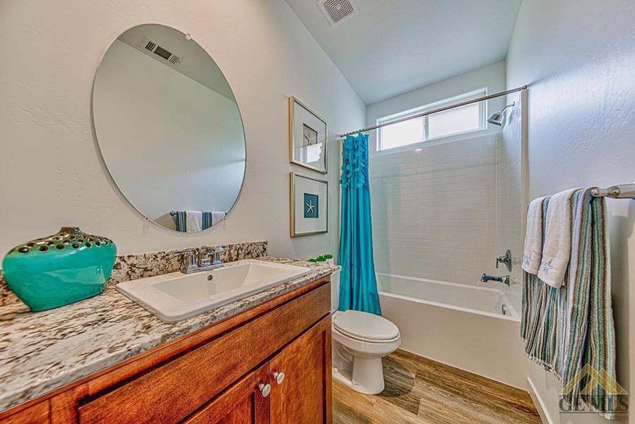 Undisclosed Address Bakersfield, CA 93311 - Photo 10 of 12 a bathroom with a sink a toilet and a bathtub