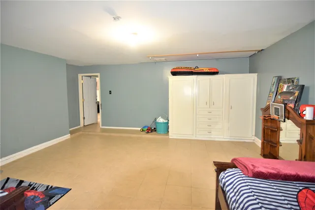 a playing room with furniture and a wooden floor