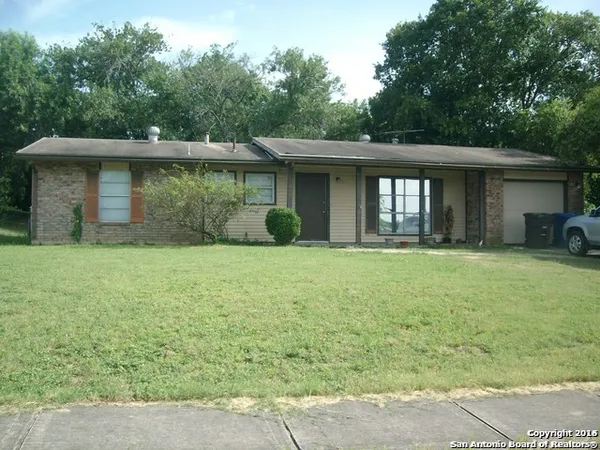 a front view of a house with yard and green space
